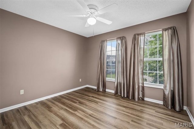 881 Sara Beth Ct, Saint Peters, MO 63376 - empty room featuring wood finished floors, a ceiling fan, and a textured ceiling