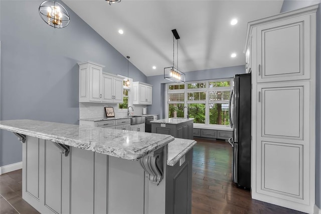 4196 Stone Crest Cpe, Girardeau, MO 63701 - kitchen featuring a kitchen island, freestanding refrigerator, a sink, dark wood finished floors, and white cabinets