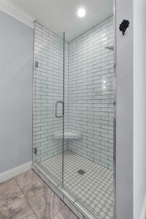 4196 Stone Crest Cpe, Girardeau, MO 63701 - bathroom featuring a stall shower, baseboards, and crown molding