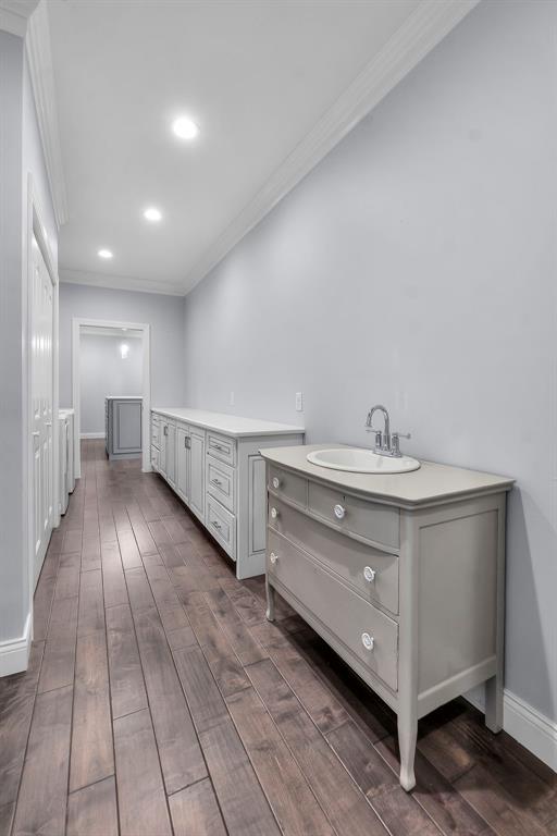 4196 Stone Crest Cpe, Girardeau, MO 63701 - hallway featuring crown molding, a sink, dark wood-style floors, baseboards, and recessed lighting