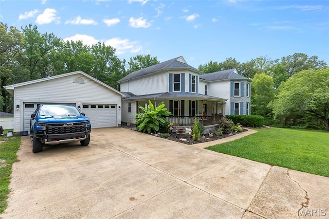 15092 State Highway Ad, Dexter, MO 63841 - victorian house with covered porch, a front yard, a detached garage, driveway, and view of wooded area
