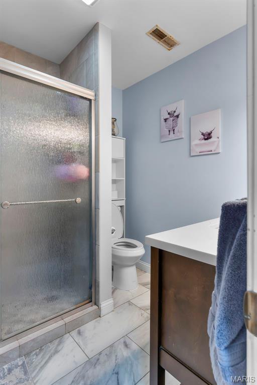 15092 State Highway Ad, Dexter, MO 63841 - bathroom featuring marble look tiles, a stall shower, and vanity