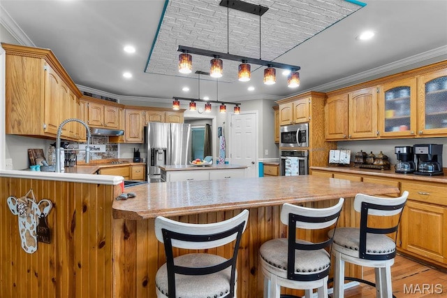 15092 State Highway Ad, Dexter, MO 63841 - kitchen featuring stainless steel appliances, crown molding, a kitchen island, light countertops, and glass insert cabinets