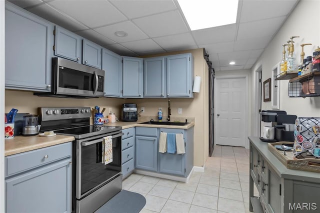 15092 State Highway Ad, Dexter, MO 63841 - kitchen with appliances with stainless steel finishes, light tile patterned floors, a drop ceiling, recessed lighting, and light countertops