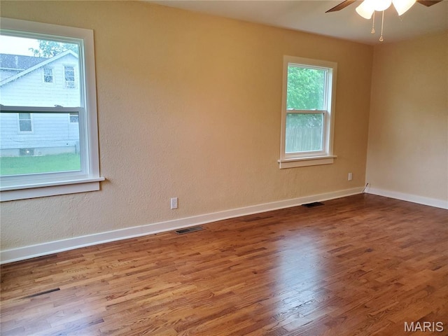 1225 Bloomfield Rd, Cape Girardeau, MO 63703 - spare room with healthy amount of natural light, wood finished floors, a ceiling fan, and baseboards