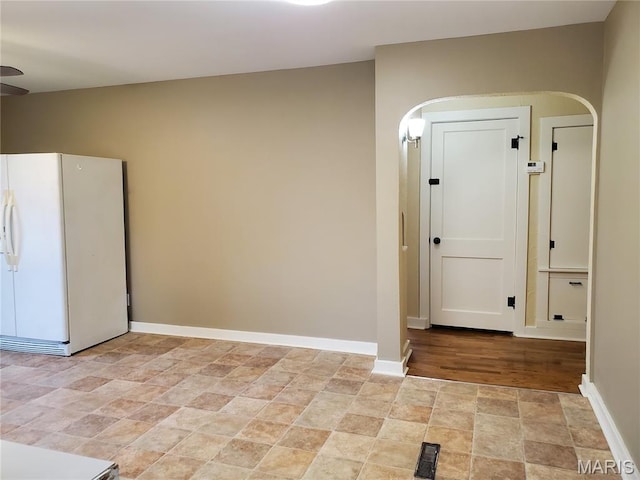 1225 Bloomfield Rd, Cape Girardeau, MO 63703 - spare room featuring stone finish flooring, arched walkways, and baseboards