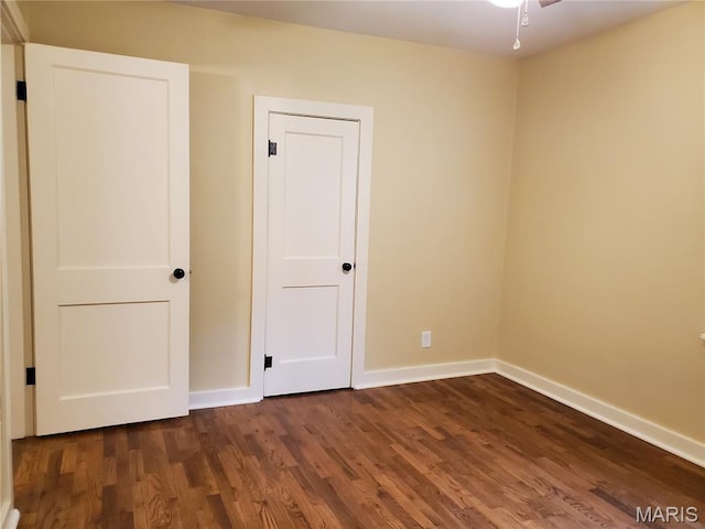 1225 Bloomfield Rd, Cape Girardeau, MO 63703 - unfurnished bedroom with baseboards and dark wood finished floors