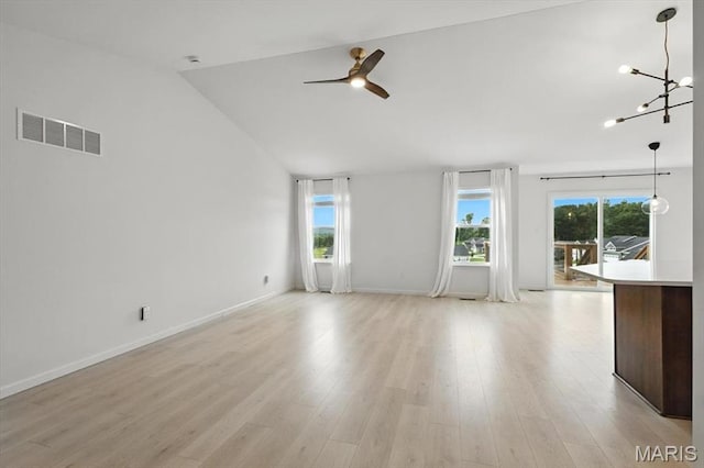 2112 Windswept Farms Dr, Eureka, MO 63025 - unfurnished living room with ceiling fan, a chandelier, light wood finished floors, and lofted ceiling