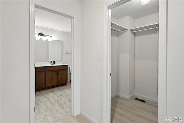 2112 Windswept Farms Dr, Eureka, MO 63025 - walk in closet with light wood-style flooring and a sink