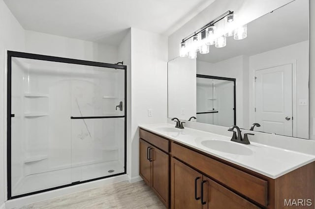 2112 Windswept Farms Dr, Eureka, MO 63025 - bathroom with a shower stall, double vanity, and wood finished floors