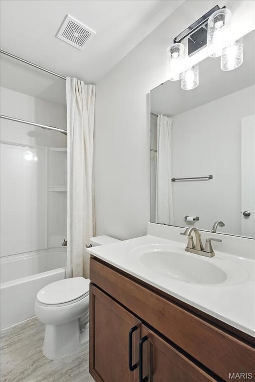 2112 Windswept Farms Dr, Eureka, MO 63025 - bathroom with vanity, shower / tub combo, and wood finished floors