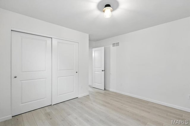 2112 Windswept Farms Dr, Eureka, MO 63025 - unfurnished bedroom featuring a closet and light wood-style flooring