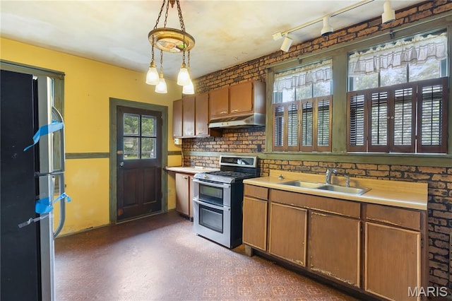 870 Tuxedo Blvd, Saint Louis, MO 63119 - kitchen featuring double oven range, under cabinet range hood, plenty of natural light, and light countertops