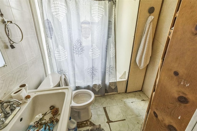 full bath featuring toilet, marble finish floors, a sink, and shower / bath combination with curtain