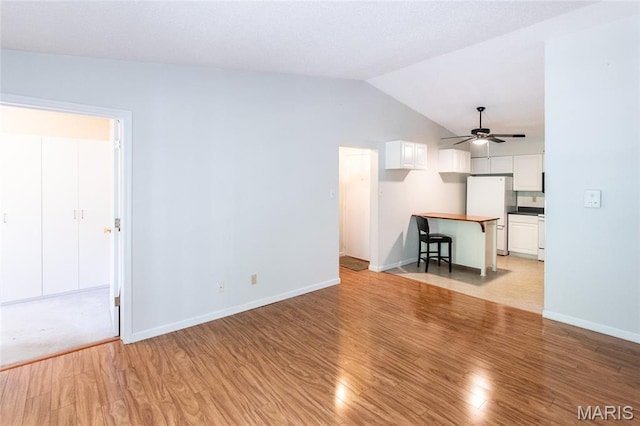 902 Hanna Place Ct Unit A, Manchester, MO 63021 - unfurnished living room with light wood finished floors, ceiling fan, and vaulted ceiling