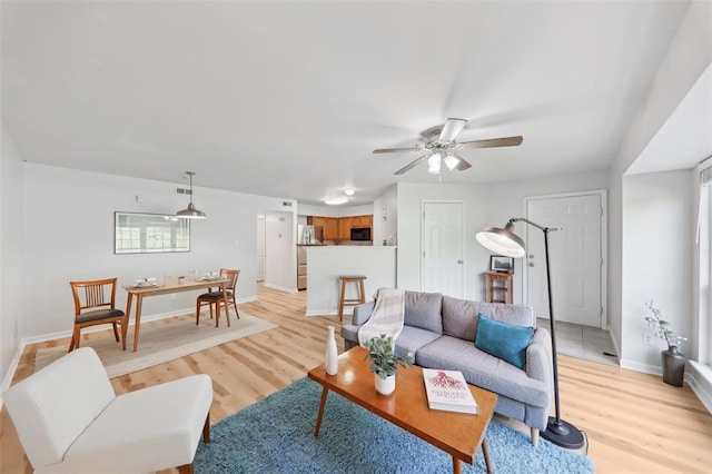 1625 Forest Springs Ln Unit A, Ballwin, MO 63021 - living room with light wood-style flooring, baseboards, and a ceiling fan