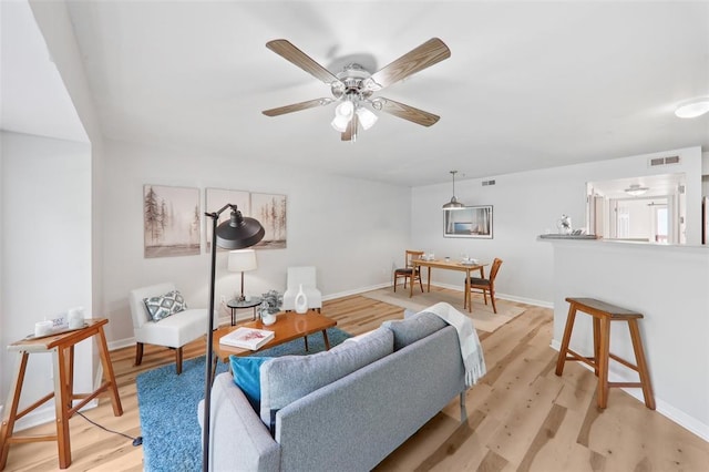 1625 Forest Springs Ln Unit A, Ballwin, MO 63021 - living area with light wood-type flooring, a ceiling fan, and baseboards