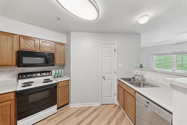1625 Forest Springs Ln Unit A, Ballwin, MO 63021 - kitchen featuring white range with electric cooktop, black microwave, dishwashing machine, a sink, and light wood-style flooring