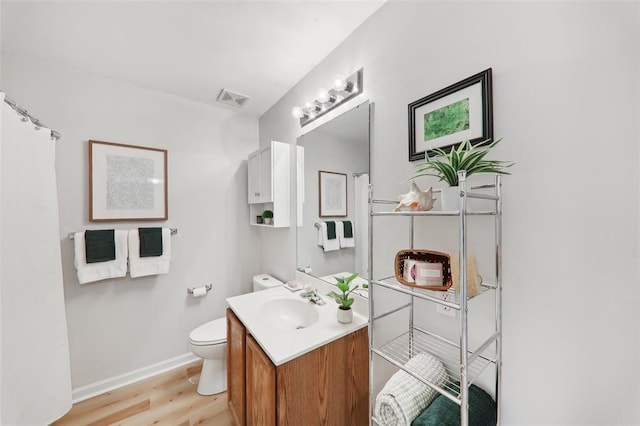 1625 Forest Springs Ln Unit A, Ballwin, MO 63021 - full bath featuring wood finished floors, toilet, vanity, and baseboards