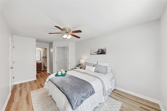 1625 Forest Springs Ln Unit A, Ballwin, MO 63021 - bedroom featuring light wood-style floors, baseboards, a ceiling fan, and connected bathroom