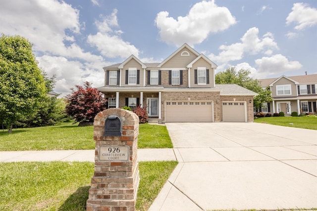 view of front of house featuring a front lawn, driveway, brick siding, a porch, and a garage