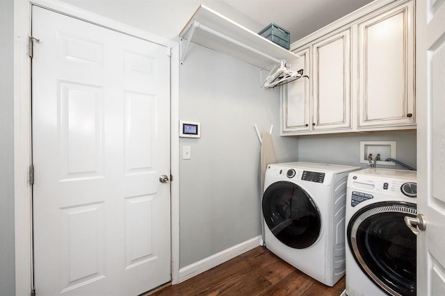 laundry area featuring cabinet space, baseboards, washer and clothes dryer, and dark wood-style flooring