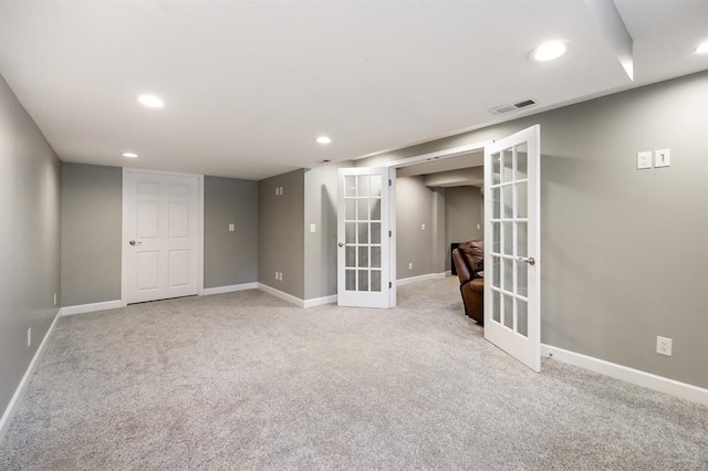 finished basement with french doors, recessed lighting, baseboards, and light colored carpet