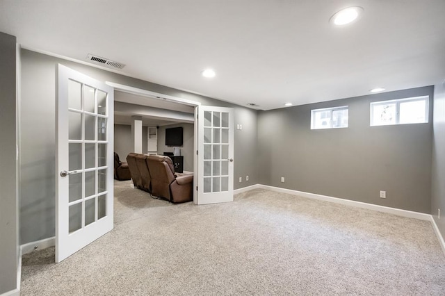 basement with french doors, carpet, recessed lighting, and baseboards