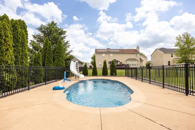 view of swimming pool featuring a water slide and fence