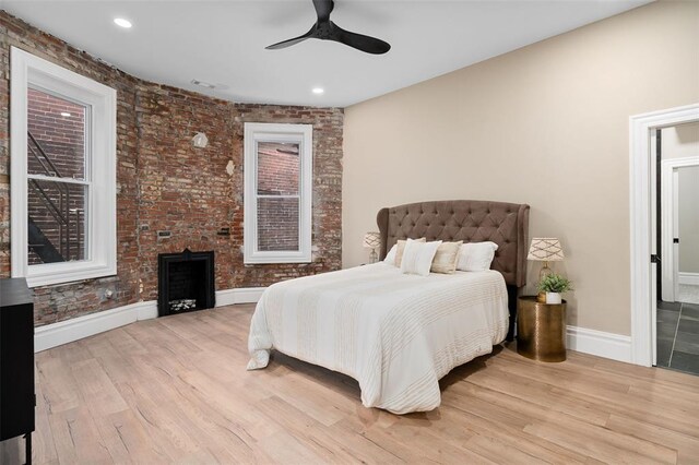 3235 S Jefferson Ave, Saint Louis, MO 63118 - bedroom with baseboards, wood finished floors, brick wall, recessed lighting, and ceiling fan
