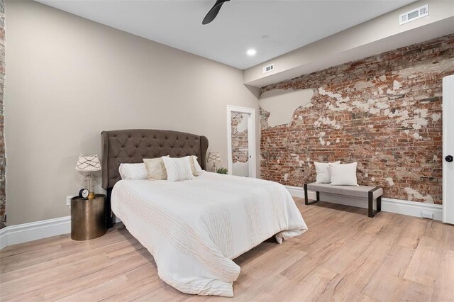 3235 S Jefferson Ave, Saint Louis, MO 63118 - bedroom with light wood-style flooring, baseboards, brick wall, a ceiling fan, and recessed lighting