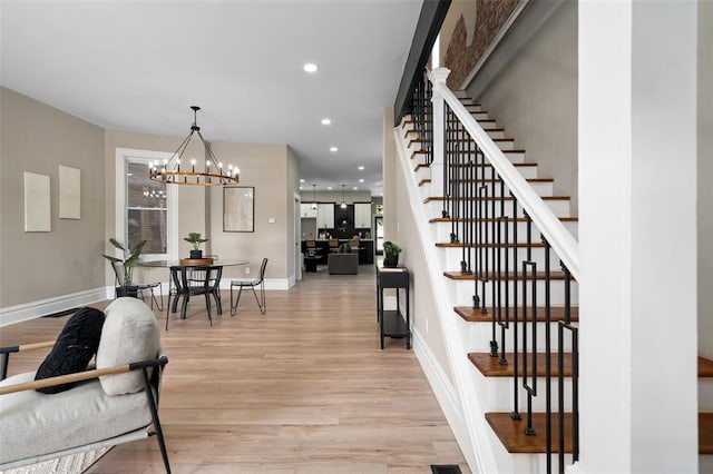 3235 S Jefferson Ave, Saint Louis, MO 63118 - stairway featuring wood finished floors, baseboards, a chandelier, and recessed lighting