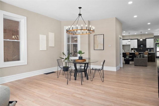 3235 S Jefferson Ave, Saint Louis, MO 63118 - dining room with baseboards, light wood finished floors, a chandelier, and recessed lighting