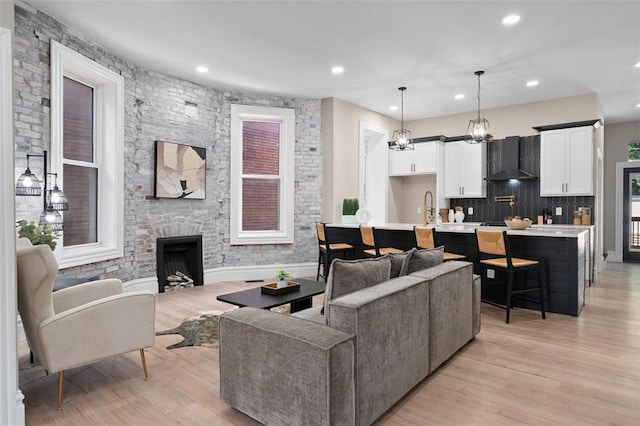 3235 S Jefferson Ave, Saint Louis, MO 63118 - living area with light wood-type flooring, recessed lighting, and a stone fireplace
