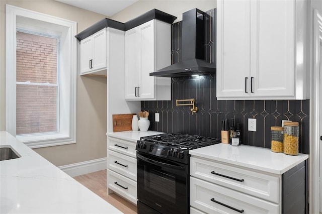 3235 S Jefferson Ave, Saint Louis, MO 63118 - kitchen featuring wall chimney exhaust hood, black range with gas cooktop, baseboards, backsplash, and light stone countertops