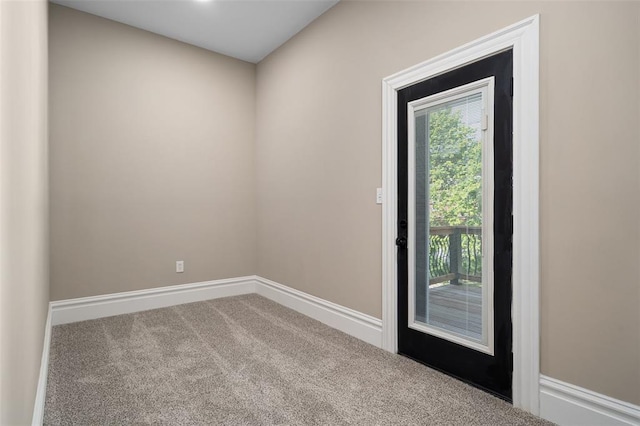 3235 S Jefferson Ave, Saint Louis, MO 63118 - doorway to outside featuring carpet and baseboards