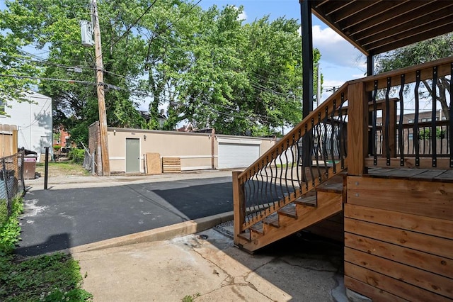 3235 S Jefferson Ave, Saint Louis, MO 63118 - wooden terrace with stairway, an outbuilding, and a garage