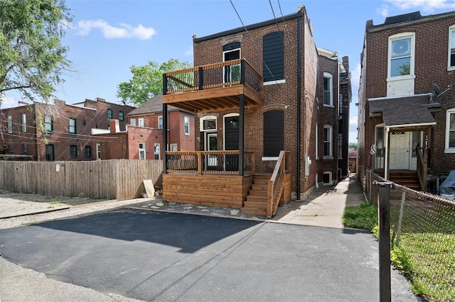 3235 S Jefferson Ave, Saint Louis, MO 63118 - multi unit property with a balcony, brick siding, and fence