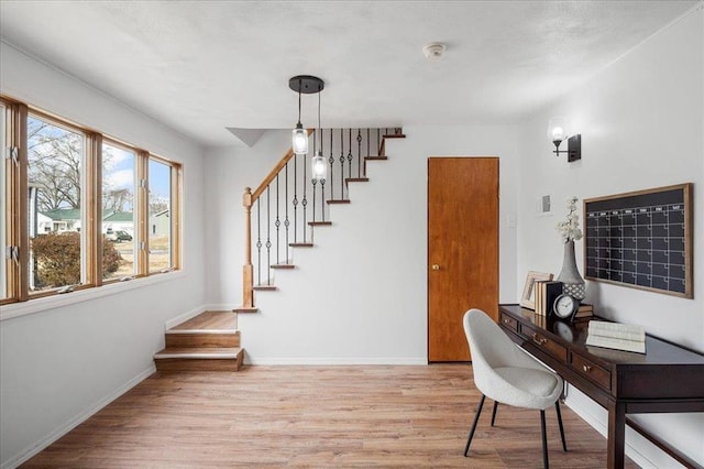 office with light wood-style flooring and baseboards