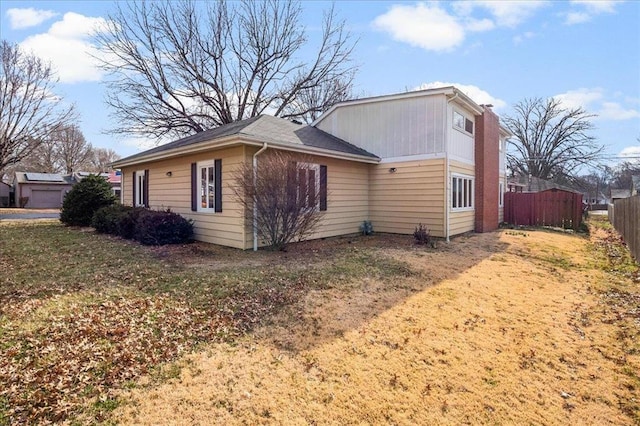 view of home's exterior with fence