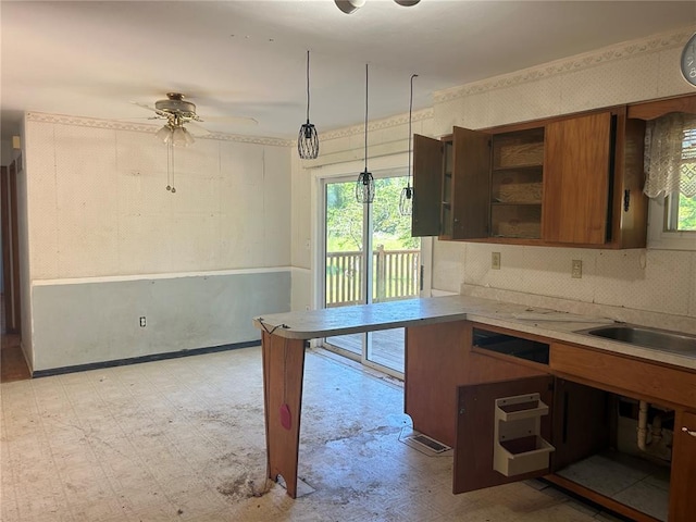 12219 Peter Moore Ln, De Soto, MO 63020 - kitchen featuring light floors, brown cabinets, light countertops, ceiling fan, and open shelves