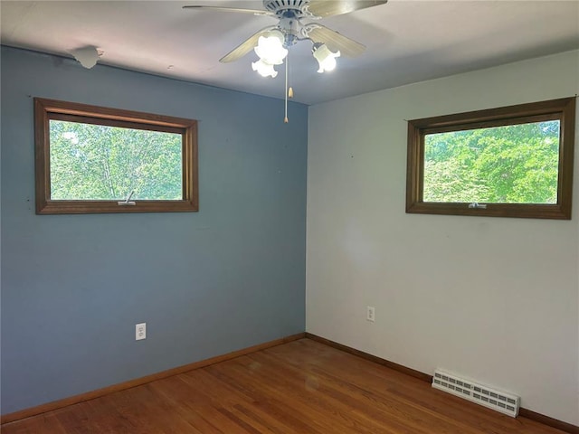 12219 Peter Moore Ln, De Soto, MO 63020 - spare room with plenty of natural light, baseboards, ceiling fan, and wood finished floors
