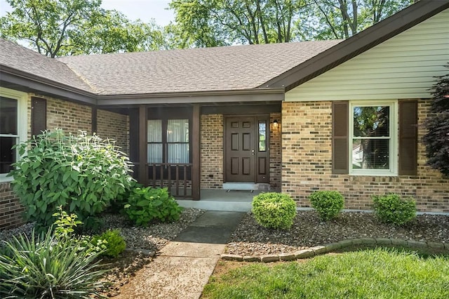 14 Wimbly Pl, Saint Charles, MO 63301 - doorway to property featuring brick siding, roof with shingles, and a porch