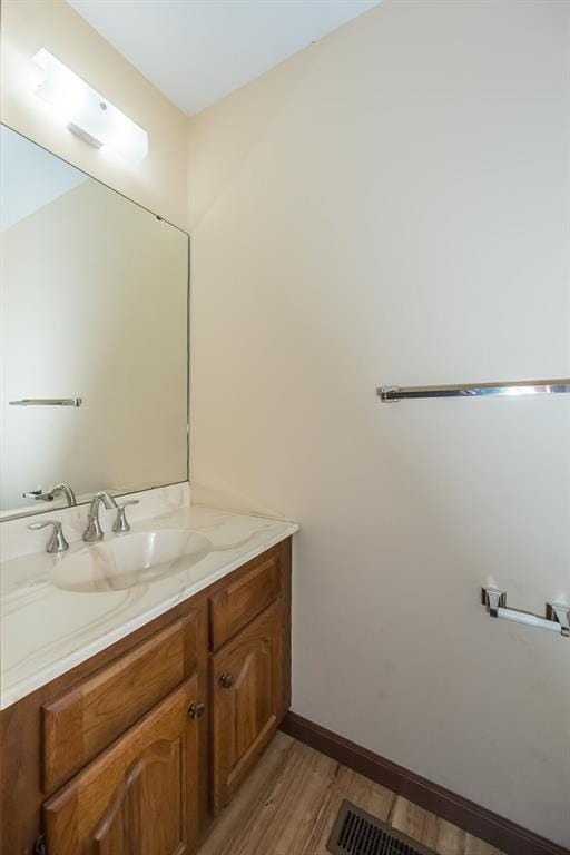 14 Wimbly Pl, Saint Charles, MO 63301 - bathroom featuring wood finished floors, vanity, and baseboards