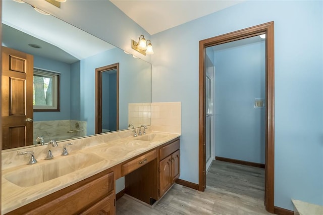 14 Wimbly Pl, Saint Charles, MO 63301 - bathroom featuring wood finished floors, double vanity, baseboards, and an enclosed shower