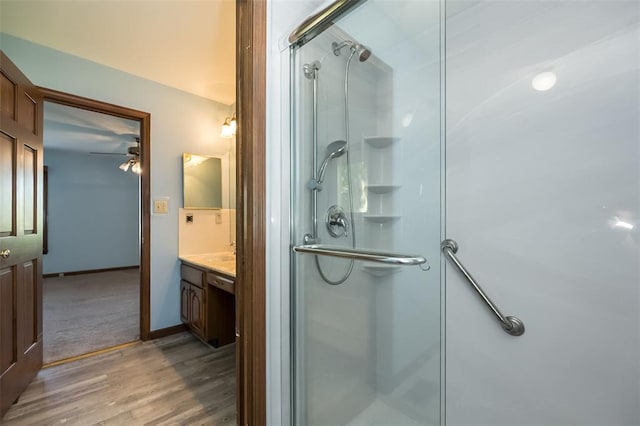 14 Wimbly Pl, Saint Charles, MO 63301 - bathroom featuring a shower stall, vanity, wood finished floors, and a ceiling fan