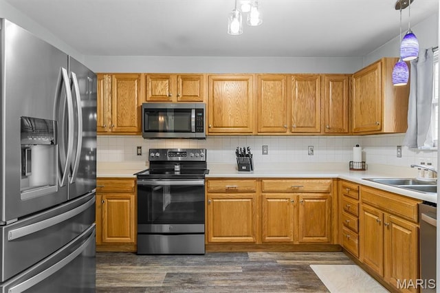 1332 Big Bend Crossing Dr, Manchester, MO 63088 - kitchen with appliances with stainless steel finishes, light countertops, dark wood-style flooring, backsplash, and hanging light fixtures