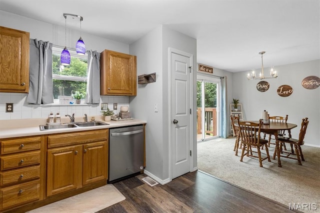 1332 Big Bend Crossing Dr, Manchester, MO 63088 - kitchen with stainless steel dishwasher, dark wood-style floors, tasteful backsplash, and brown cabinetry