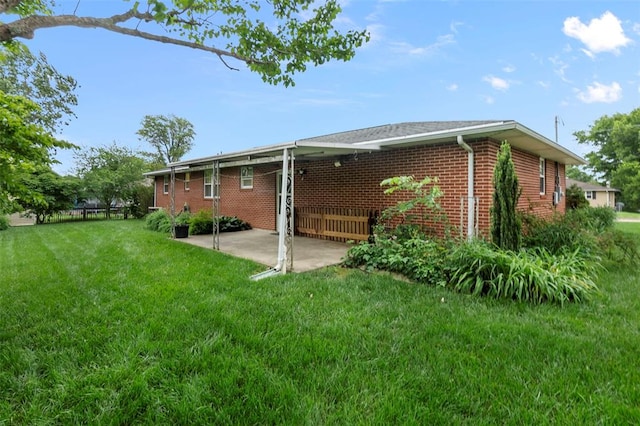626 Sue Dr, Jackson, MO 63755 - rear view of house featuring a patio area, a lawn, and brick siding