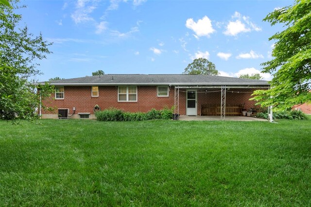 626 Sue Dr, Jackson, MO 63755 - rear view of property featuring a patio, central AC, a lawn, and brick siding
